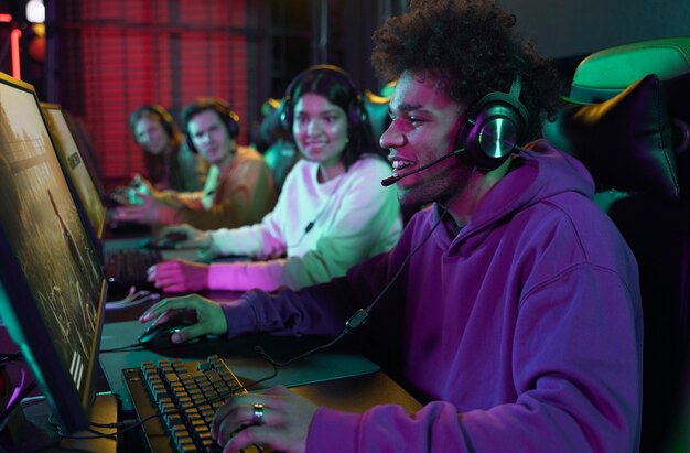 Diverse high school students competing in an ESports gaming lab with headsets